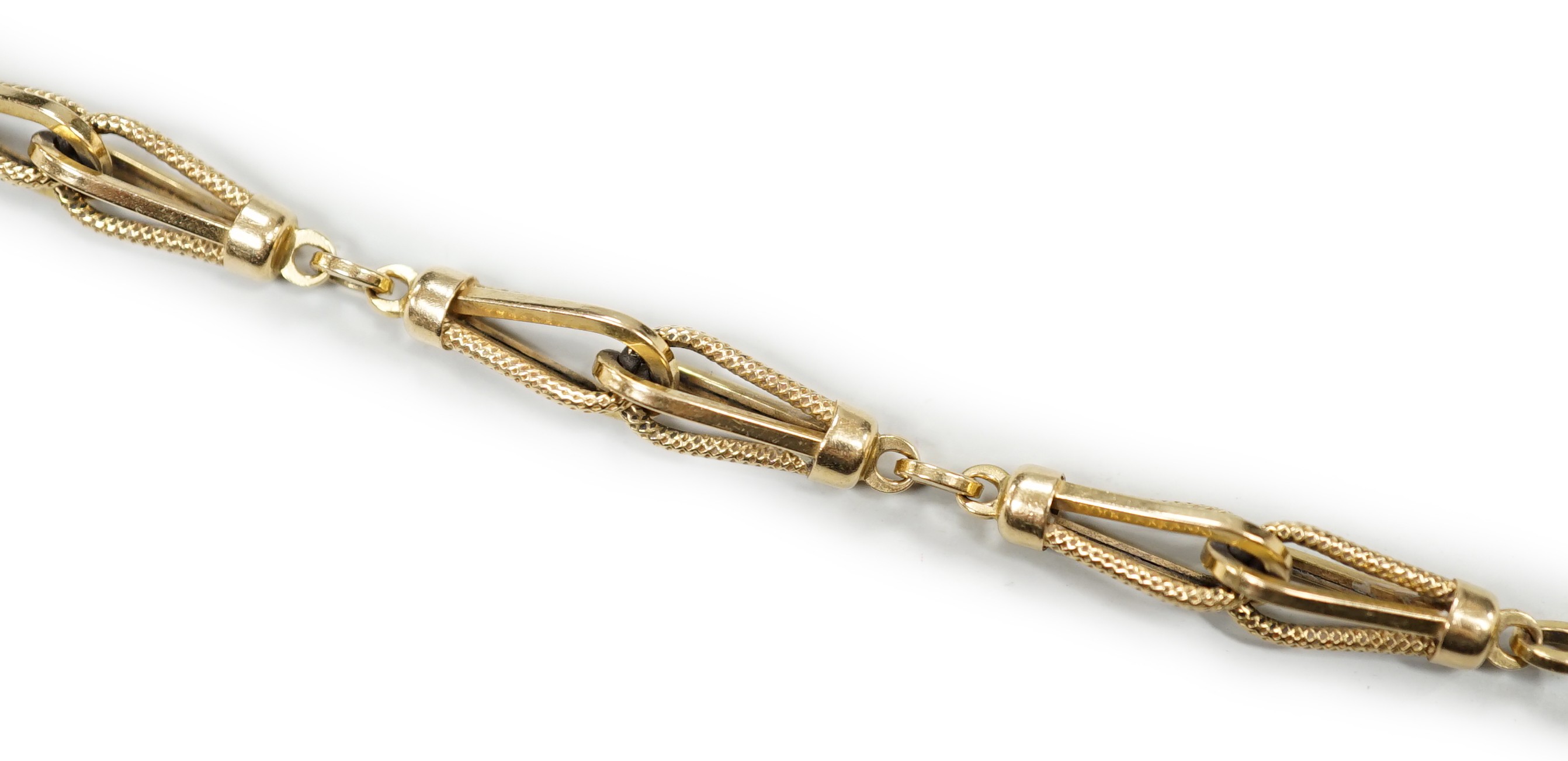 An 18k yellow metal fancy link bracelet with 14k clasp, 21cm, 10.7 grams.